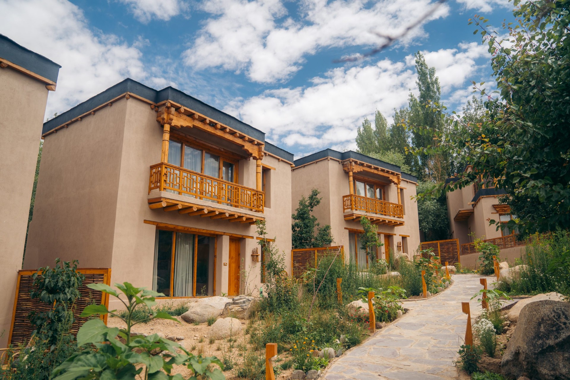 Dolkhar villas with Ladakhi woodwork and garden pathways