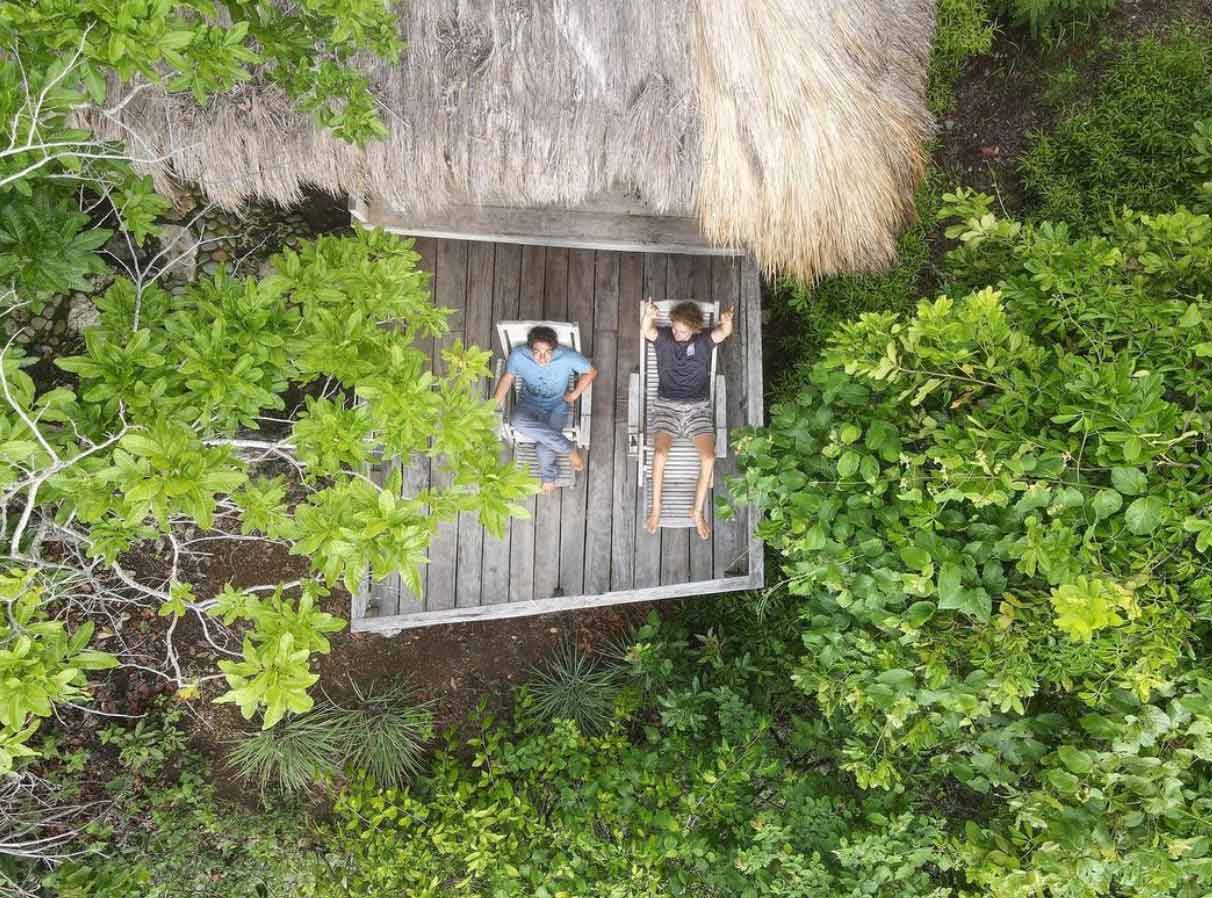 Relaxing at a thatched-roof bungalow