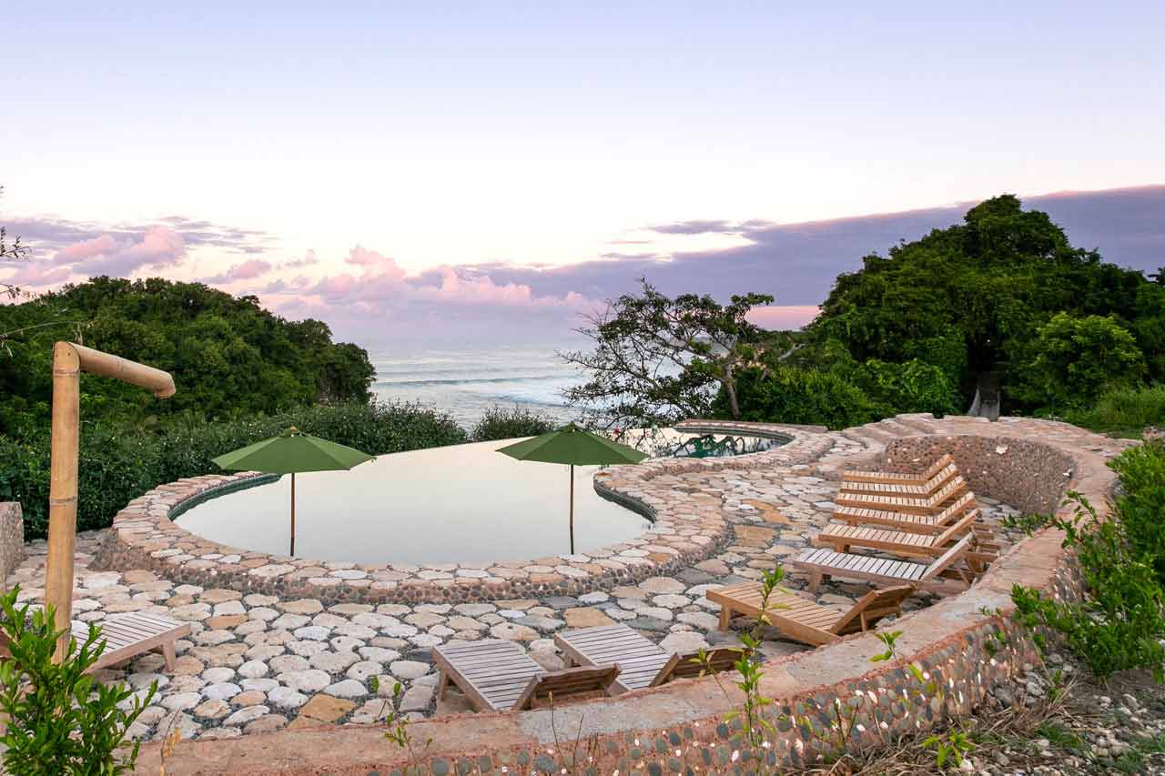 Solar-powered infinity pool at sunset