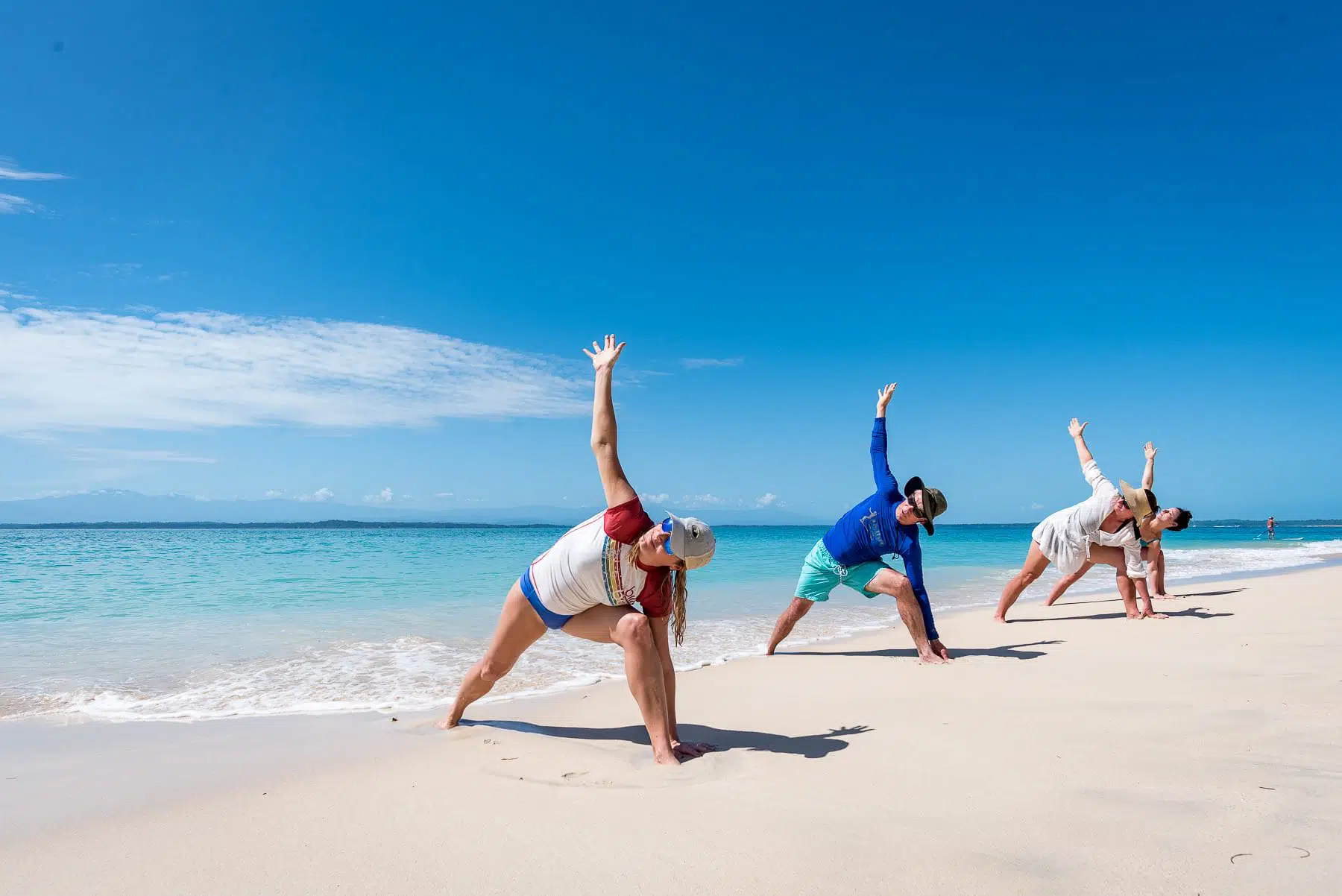 Beach yoga practice on white sand beach with Caribbean Sea backdrop